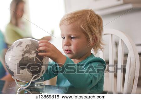 Young girl looking at globe View Large Photo Image Stock Photography - Young girl looking at globe. Fotosearch