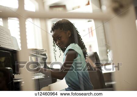 Young girl playing piano View Large Photo Image Picture - Young girl playing piano. Fotosearch