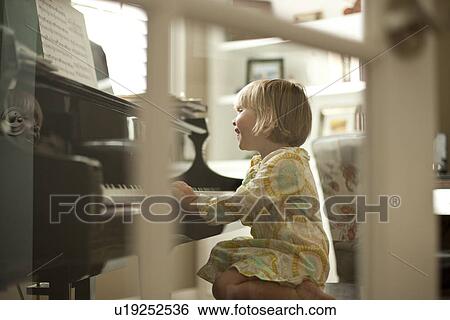 Young girl playing piano View Large Photo Image Stock Photograph - Young girl playing piano. Fotosearch