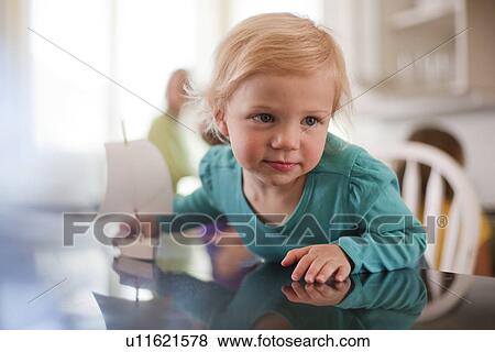 Young girl playing with toy boat View Large Photo Image Stock Photo - Young girl playing with toy boat. Fotosearch