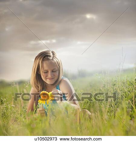 Young girl pulling petals off of gerbera daisy View Large Photo Image Stock Image - Young girl pulling petals off of gerbera daisy. Fotosearch