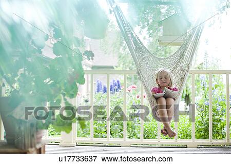 Young girl reading in hammock View Large Photo Image Stock Photo - Young girl reading in hammock. Fotosearch
