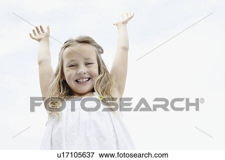 Stock Photo - Young girl with her arms raised. Fotosearch