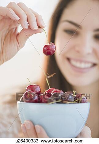 Young woman holding a bowl of cherries View Large Photo Image Stock Image - Young woman holding a bowl of cherries. Fotosearch