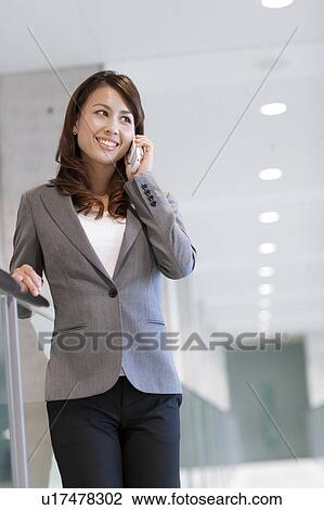A business woman talking on the phone View Large Photo Image Stock Image - A business woman talking on the phone. Fotosearch