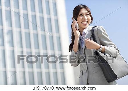 A business woman talking on the phone View Large Photo Image Stock Image - A business woman talking on the phone. Fotosearch