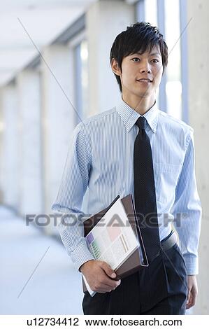 A businessman holding file View Large Photo Image Stock Image - A businessman holding file. Fotosearch