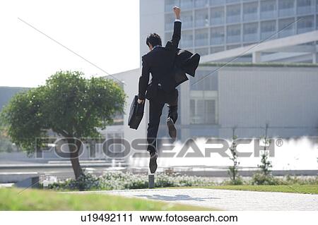 Stock Image - A businessman jumping. Fotosearch