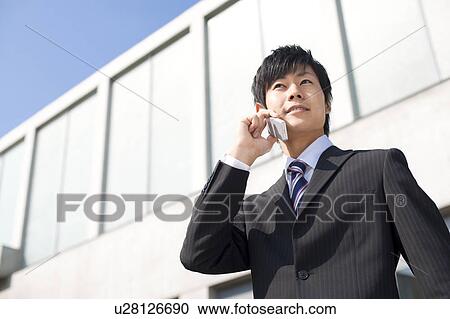 Stock Image - A businessman on the phone. Fotosearch