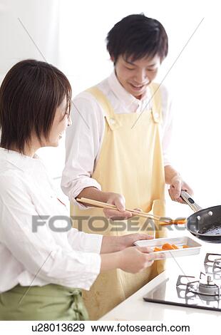 A couple cooking together View Large Photo Image Stock Photo - A couple cooking together. Fotosearch