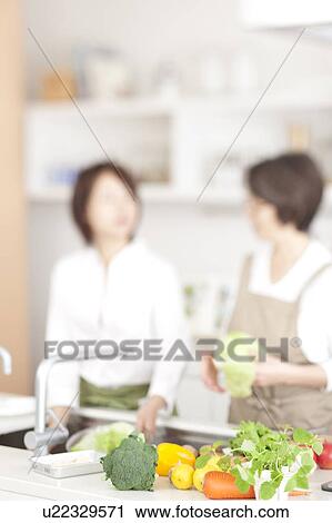 Stock Image - A family cooking. Fotosearch