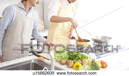 A family cooking View Large Photo Image Stock Photo - A family cooking. Fotosearch