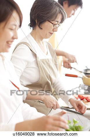 A family cooking View Large Photo Image Stock Photo - A family cooking. Fotosearch
