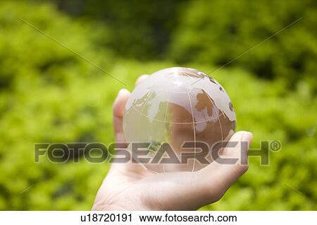 Stock Image - A hand holding globe. Fotosearch