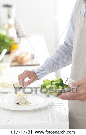 A man preparing meal View Large Photo Image Stock Image - A man preparing meal. Fotosearch