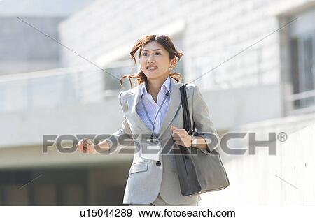 Stock Photo - A running business woman. Fotosearch