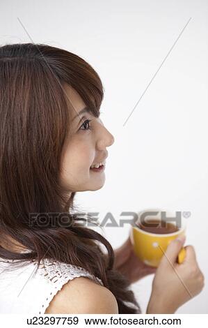 A woman holding a hot drink View Large Photo Image Stock Photo - A woman holding a hot drink. Fotosearch