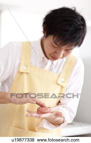 A young man cooking hamburger stake View Large Photo Image Stock Photo - A young man cooking hamburger stake. Fotosearch