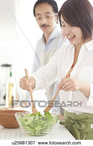 A young woman making salad View Large Photo Image Stock Photo - A young woman making salad. Fotosearch