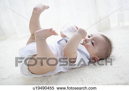 Stock Photography - Baby Boy Drinking Milk From Bottle. Fotosearch