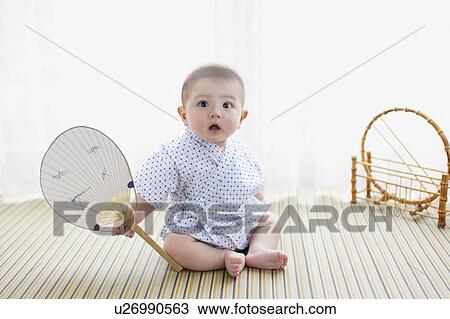 Baby Boy Holding Fan and Looking Surprised View Large Photo Image Stock Image - Baby Boy Holding Fan and Looking Surprised. Fotosearch