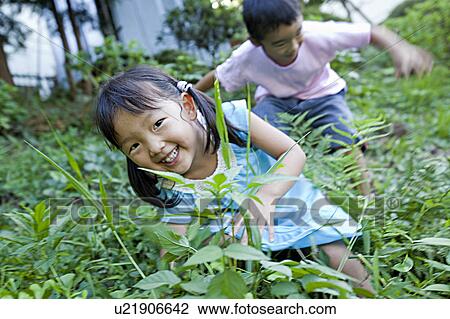 Boy and girl in bush, Japan View Large Photo Image Stock Image - Boy and girl in bush, Japan. Fotosearch