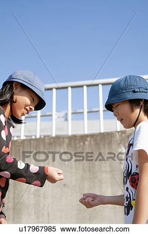 Boy and girl playing Rock Paper Scissors, Japan View Large Photo Image Stock Photography - Boy and girl playing Rock Paper Scissors, Japan. Fotosearch