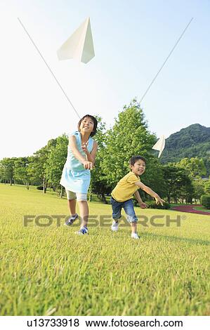Boy and Girl Throwing Paper Airplanes View Large Photo Image Stock Photo - Boy and Girl Throwing Paper Airplanes. Fotosearch