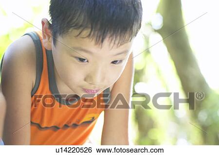 Stock Photograph - Boy bending over, close up. Fotosearch