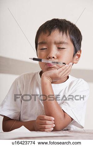 Picture - Boy doing homework, Japan. Fotosearch