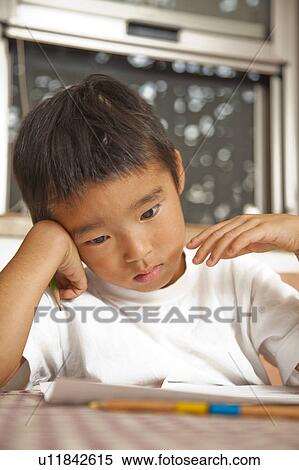 Stock Photography - Boy doing homework, Japan. Fotosearch