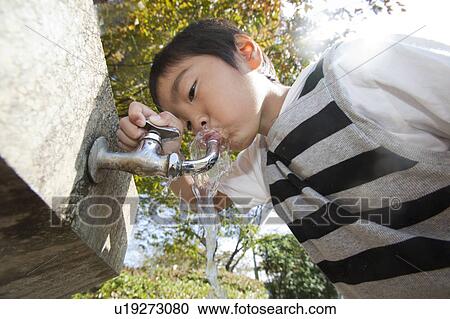Boy drinking water from faucet, Japan View Large Photo Image Stock Image - Boy drinking water from faucet, Japan. Fotosearch
