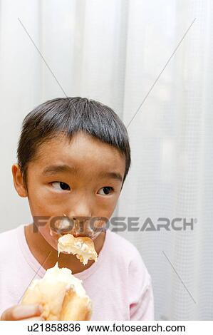 Stock Photograph - Boy eating ice cream, Japan. Fotosearch