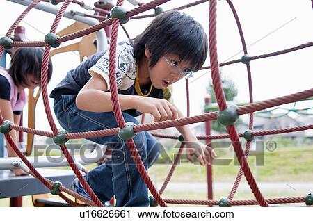 Boy going through a tunnel at playground, Japan View Large Photo Image Stock Image - Boy going through a tunnel at playground, Japan. Fotosearch