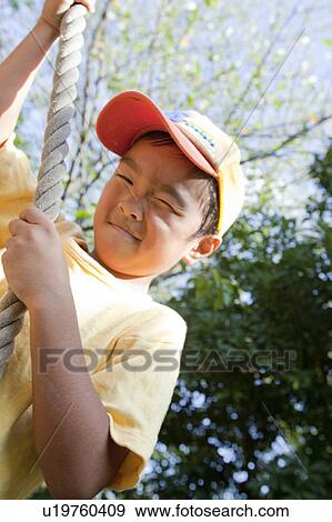 Boy hanging from a rope at a playground, Japan View Large Photo Image Stock Photo - Boy hanging from a rope at a playground, Japan. Fotosearch