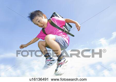 Boy jumping in air, Japan View Large Photo Image Stock Image - Boy jumping in air, Japan. Fotosearch