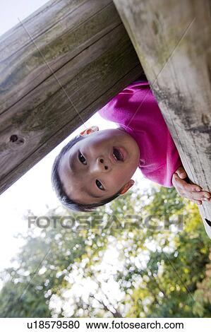 Boy looking down from a jungle gym, Japan View Large Photo Image Stock Image - Boy looking down from a jungle gym, Japan. Fotosearch