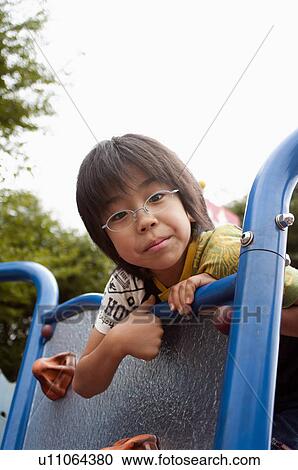 Stock Image - Boy on jungle gym, Japan. Fotosearch