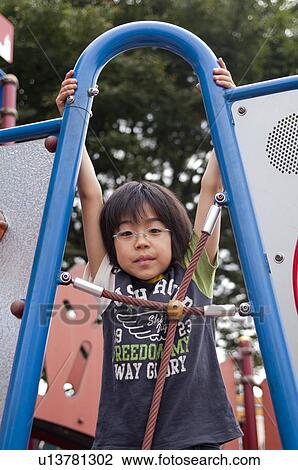 Boy on jungle gym, Japan View Large Photo Image Stock Image - Boy on jungle gym, Japan. Fotosearch
