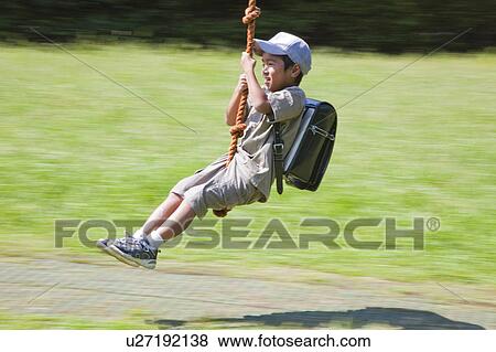 Boy on rope swing, Japan View Large Photo Image Stock Photo - Boy on rope swing, Japan. Fotosearch