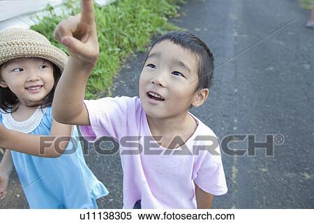 Boy pointing sky, Japan View Large Photo Image Stock Photography - Boy pointing sky, Japan. Fotosearch