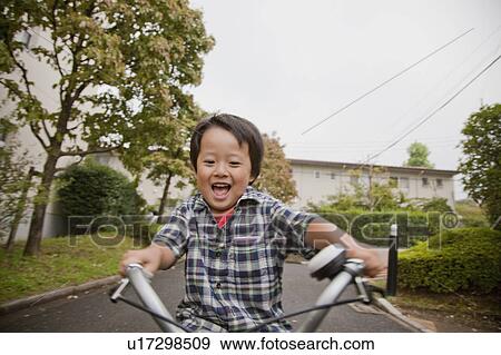 Stock Photo - Boy riding a bicycle, Tokyo Prefecture, Honshu, Japan. Fotosearch