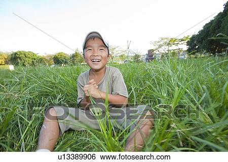 Boy sitting on grass, Japan View Large Photo Image Stock Photograph - Boy sitting on grass, Japan. Fotosearch