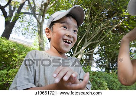 Boy wearing baseball cap smiling, Japan View Large Photo Image Stock Image - Boy wearing baseball cap smiling, Japan. Fotosearch