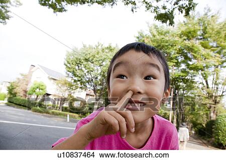 Picture - Boy with finger up his nose, Japan. Fotosearch