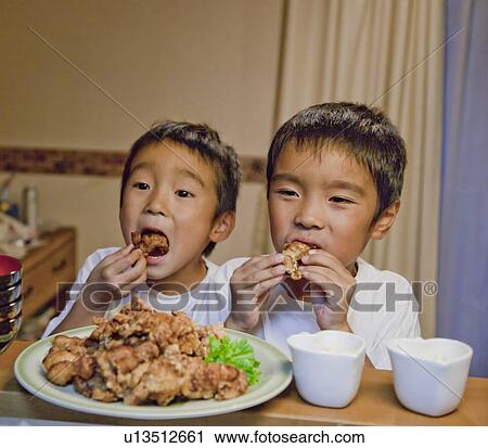 Boys eating fried chicken, Japan View Large Photo Image Stock Image - Boys eating fried chicken, Japan. Fotosearch