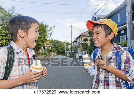 Stock Photo - Boys eating ice cream, Tokyo Prefecture, Honshu, Japan. Fotosearch