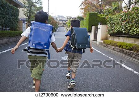 Boys holding hands and running, Tokyo Prefecture, Honshu, Japan View Large Photo Image Stock Image - Boys holding hands and running, Tokyo Prefecture, Honshu, Japan. Fotosearch