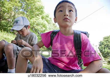 Boys sitting at park, Japan View Large Photo Image Stock Photograph - Boys sitting at park, Japan. Fotosearch