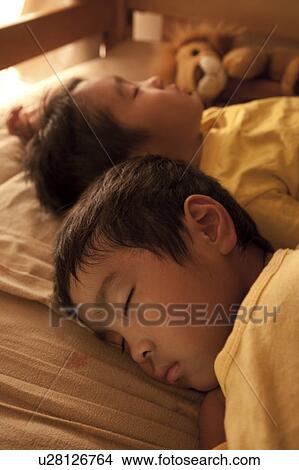 Picture - Boys sleeping in bed, Japan. Fotosearch